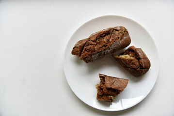 Pieces of black bread loaf on a white plate