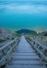 Wooden staircase leading from the mountains to the sea. Paradise place for tourism and recreation. Hiking.