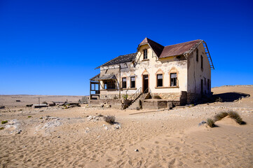 abandoned house filled with desert sand in kolmanskop,namibia