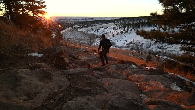 Hiking downhill in Boulder Colorado at sunrise, winter time