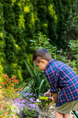 Little toddler boy play in garden in spring