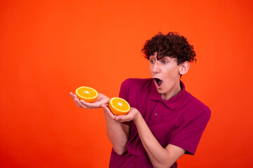 Young attractive guy and juicy oranges.	