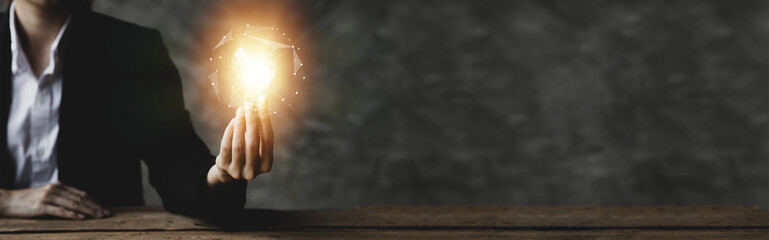 Standing woman holding glowing lamp, Creative new idea. Innovation, brainstorming, strategizing to make the business grow and be profitable. Concept execution, strategy planning and profit management.