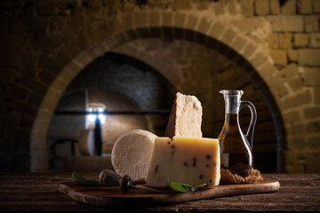 Forms of homemade pecorino cheese on wooden table