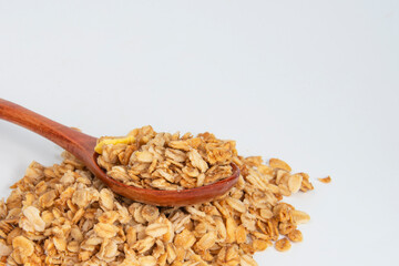 Oatmeal cereal breakfast in wooden spoon isolated on the white background