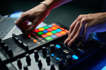 Dj plays beats on drum machine.Hip hop disc jockey playing on concert stage with professional midi...