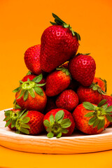 Fresh strawberries on orange background