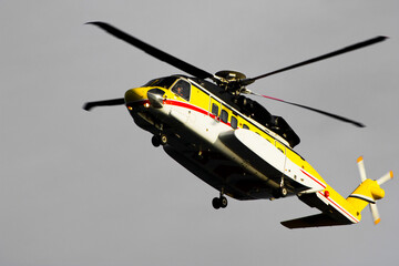 Fototapeta premium A helicopter on top of a offshore oil-platform transporting roughnecks to nearby rigs