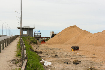 Preparation of infrastructure for a new bridge on the shore.