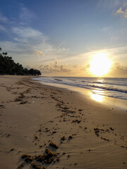 Footsteps on beautiful beach at dawn 