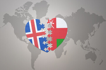 puzzle heart with the national flag of oman and iceland on a world map background. Concept.