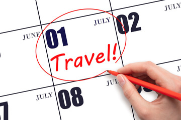 Hand drawing a red circle and writing the text TRAVEL on the calendar date 1July. Travel planning.