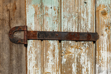 rusty metal door hinge. Door hinge on a wooden wall.