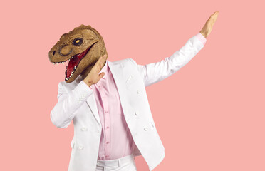 Funny weird guy in wacky animal mask having fun at crazy party. Eccentric man in white suit and...