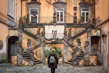 Foto op Aluminium Woman looking at the famous staircases of Palazzo Marigliano, Naples, Italy. Palazzo Marigliano is a historical, renaissance-style  palace in Naples city center. © Maurizio De Mattei
