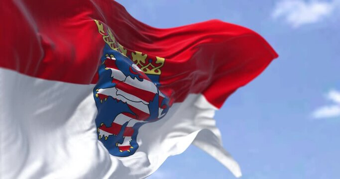 Seamless loop in slow motion with the flag of Hesse waving in the wind on a clear day