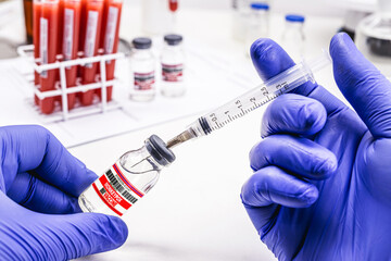 pharmacist's hand with latex glove preparing monkeypox vaccine, pharmaceutical laboratory