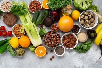 Overhead view of vegetables and nuts on light surface, cooking and clean eating concept