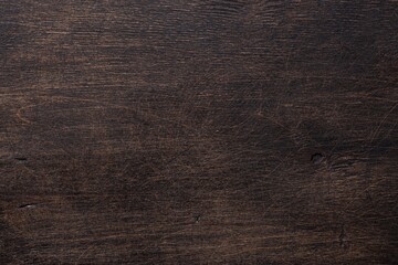 The old wooden background is dark brown with scuffs and scratches. View from above. Space for text.