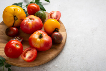 Ripe homegrown tomatoes on cutting board organic food concept