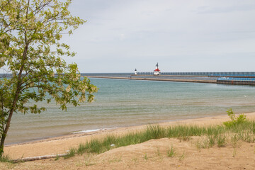 Sand beach and beachgrass with St. Joseph North Pier Inner Lighthouse and St. Joseph North Pierhead...