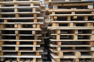 Piles of wooden pallets stored for recycling closeup