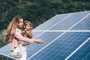 Mother teaching her daughter about sustainable energy.