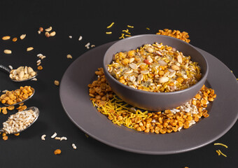 Bhel puri namkeen Chaat savoury snack served in a bowl isolated on dark background side view of nimko muri