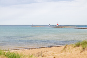 Sand beach and beachgrass with St. Joseph North Pier Inner Lighthouse and St. Joseph North Pierhead...