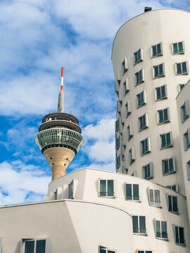 Curved modern art buildings with TV tower in background
