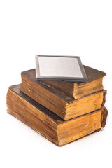 e-book on stack of worn vintage books on white background.