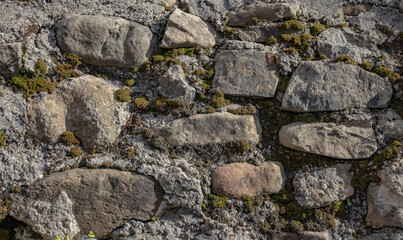 Stone wall covered by moss background