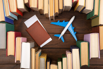 Education abroad creative concept. Heart shape of books and airplane on the wooden desk. Love to...