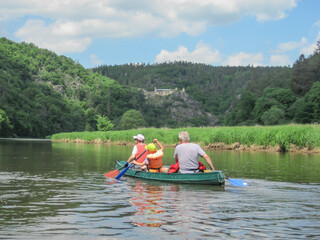 Fototapeta na wymiar Canoeing on the river, grass, forest