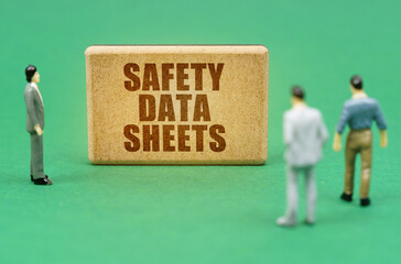 On the green surface are figures of people and a sign with the inscription - Safety Data Sheets