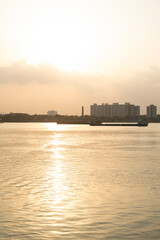 Sunray reflect on the Ganga River beside Hooghly Bridge. Princep Ghat at Kolkata. Beautiful sunset.  A beautiful scene Howrah and Ganga river from Princep Ghat at Kolkata.