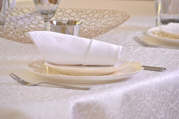 Тable setting in beige shades in a restaurant