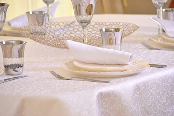 Тable setting in beige shades in a restaurant