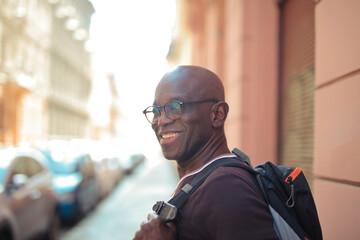 portrait of a black smiling man in the street