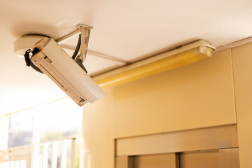 Old security control camera on a ceiling.