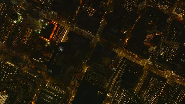 Aerial birds eye overhead top down view of streets and blocks of high rise buildings. Fly above night city. Manhattan, New York City, USA