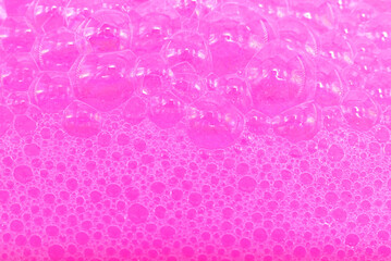 Soap foam. Background of dusty foam with bubbles of pink color for an inscription. Soap sud with copy-space