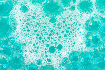 Soap foam. Background of dusty foam with bubbles of blue color for an inscription. Soap sud with copy-space