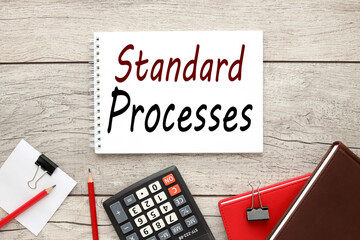 STANDARD PROCESS. notebook on table with text near stationery