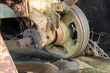 Old round rusty wheel agricultural machinery. Steampunk spokes. High quality photo