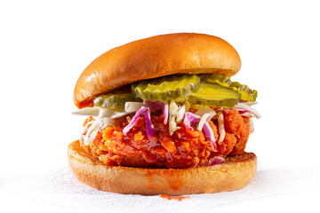 Spicy country fried chicken sandwich on a brioche bun with pickles and coleslaw  white background  copy space