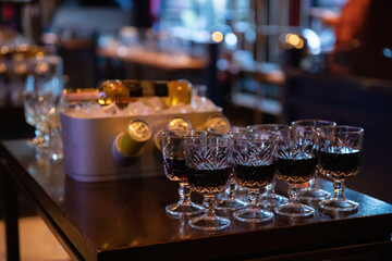 Glasses of wine on the table and wine in ice.
