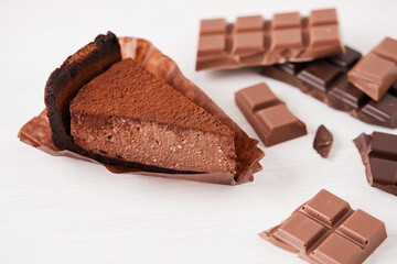 chocolate cake dessert on a white background with pieces of chocolate