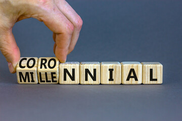 Millennial or coronnial symbol. Doctor turns wooden cubes and changes the concept word Millennial to Coronnial. Beautiful grey table grey background. Millennial or coronnial concept. Copy space.