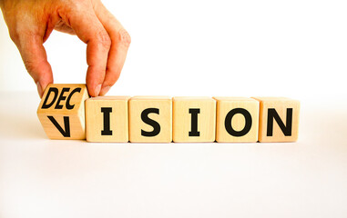 Vision and decision symbol. Businessman turns wooden cubes and changes the concept word decision to vision. Beautiful white table white background. Business vision and decision concept. Copy space.